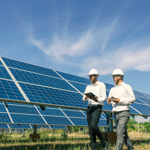 men walking in front of solar panels