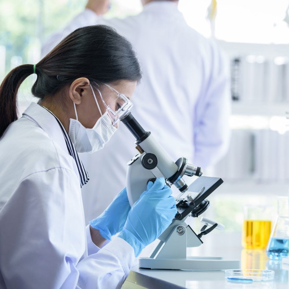 researcher-looking-through-microscope