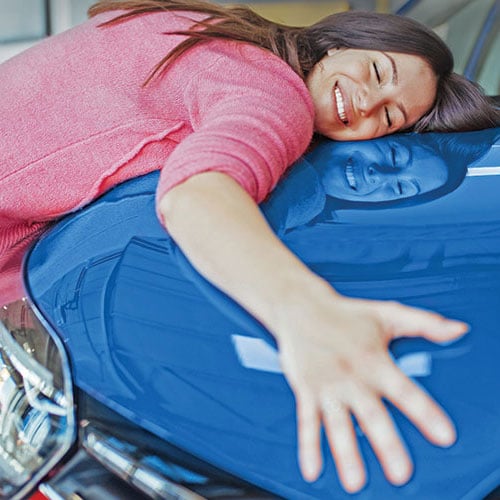 Woman hugging car