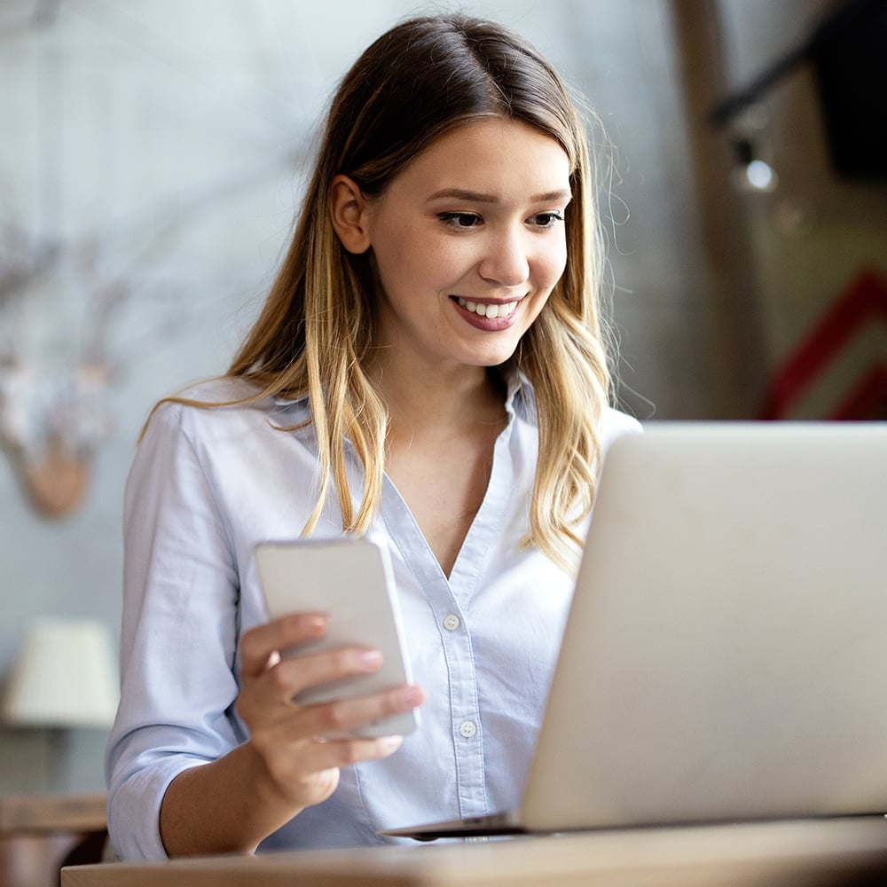 woman-working-on-pc-with-iphone_1000x1000