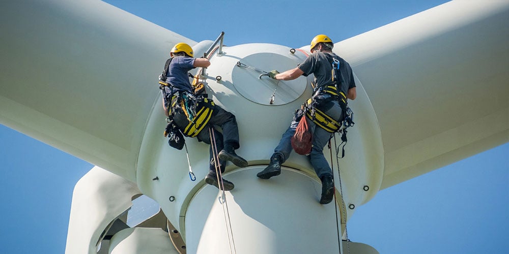 workers servicing windmill