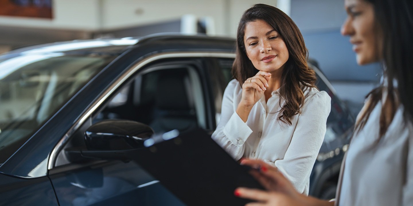 Woman at a car dealership