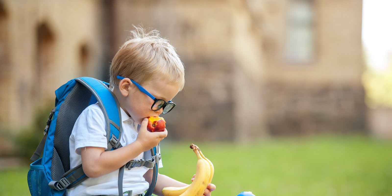 Little boy eating fruits