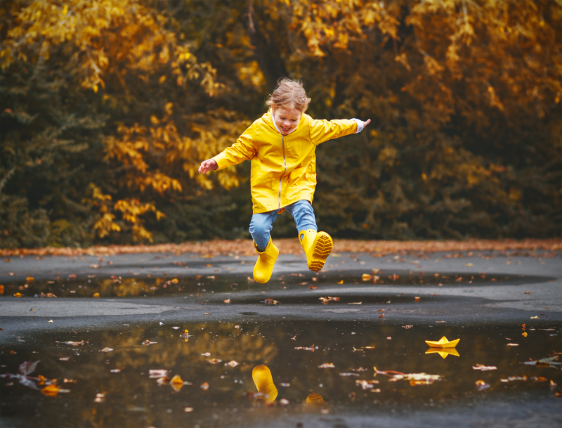 Girl jumping in puddle