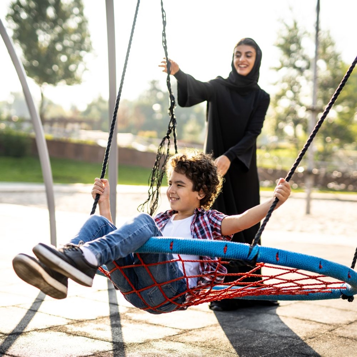 woman and child playing in the square