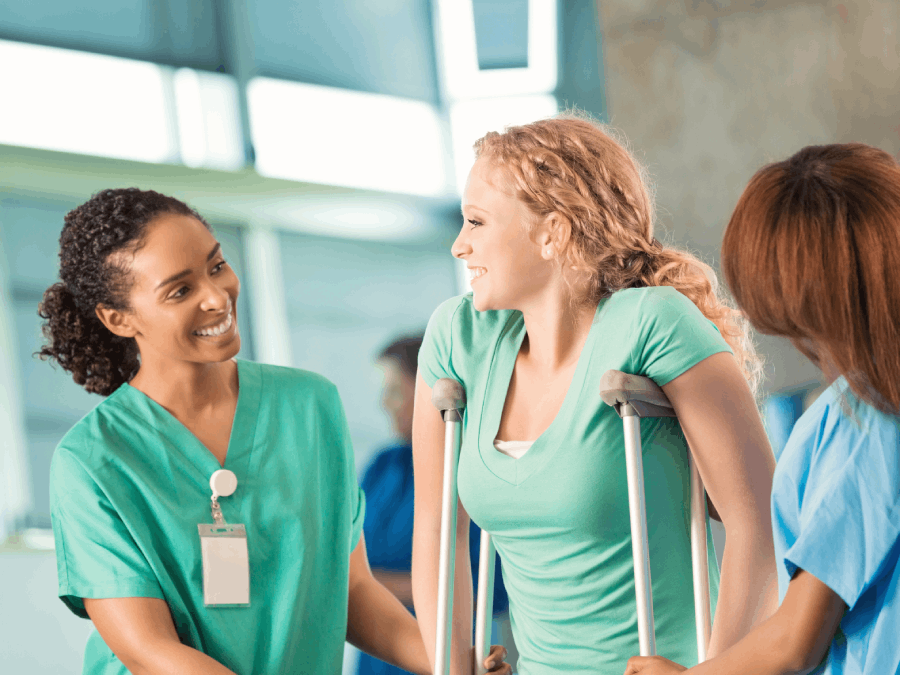 Injured woman on crutches with medical staff.