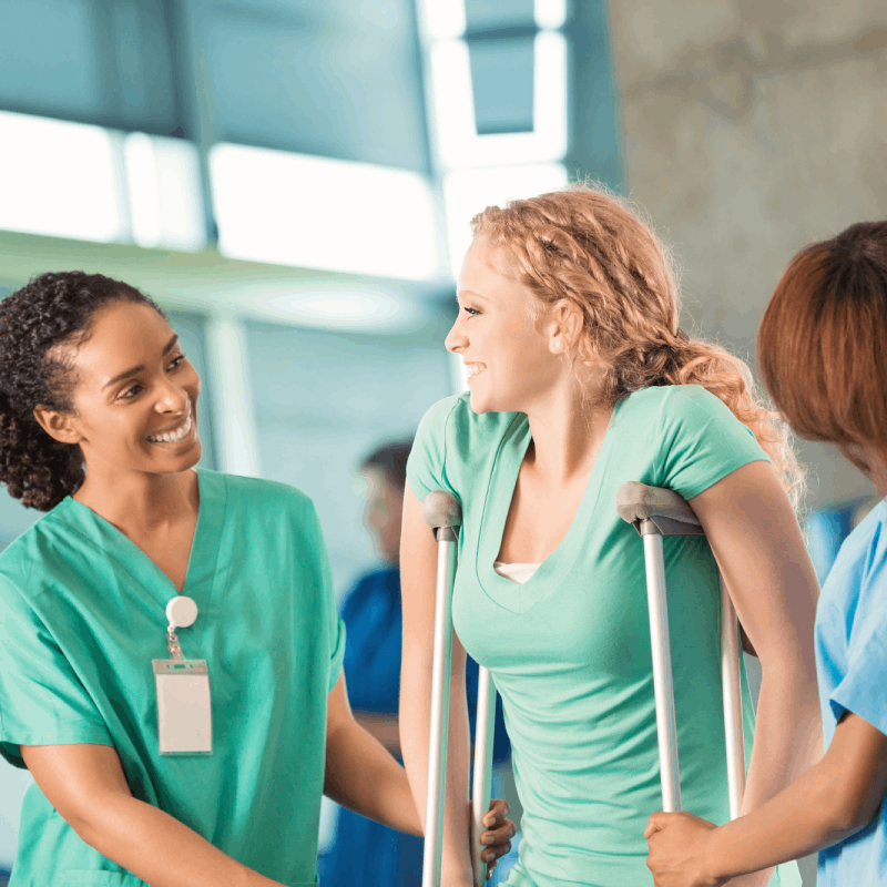 Injured woman on crutches with medical staff.