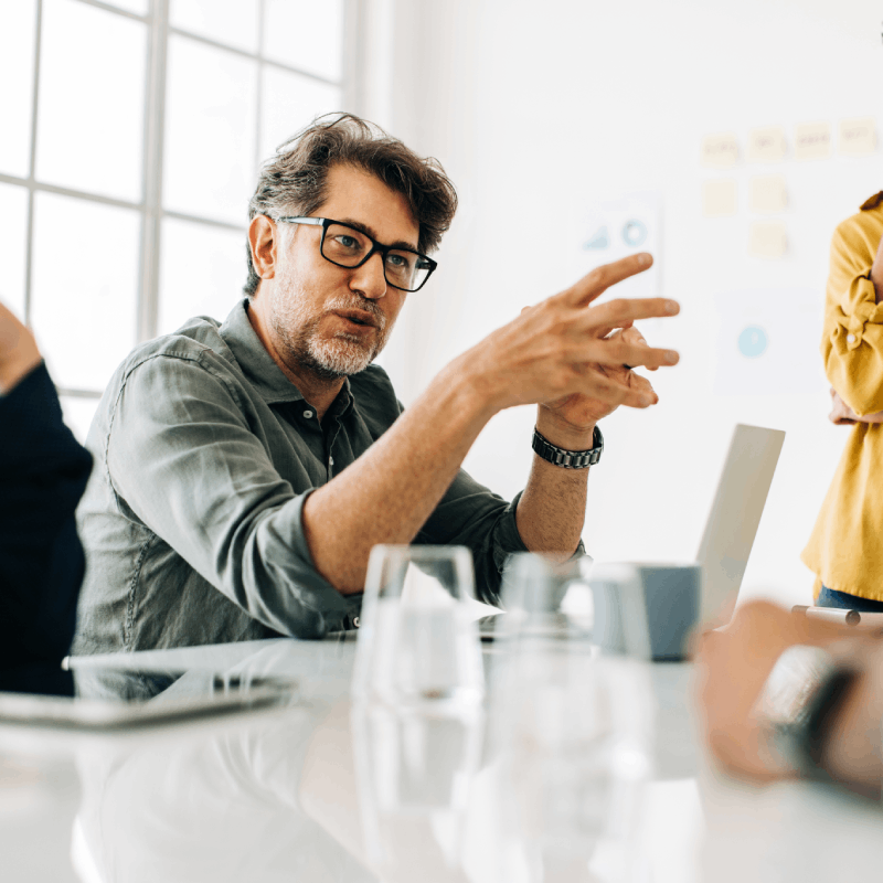 Person speaking during a business meeting.