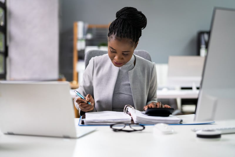 African American accountant with calculator