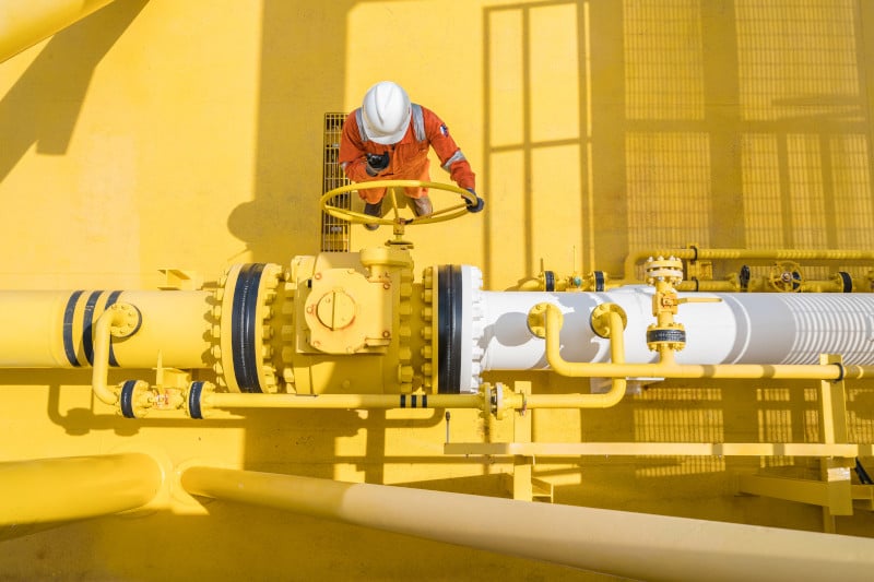Production operator communicate between central control room by using radio to operate ball valve at offshore oil and gas processing platform for control gases and liquid crude oil process