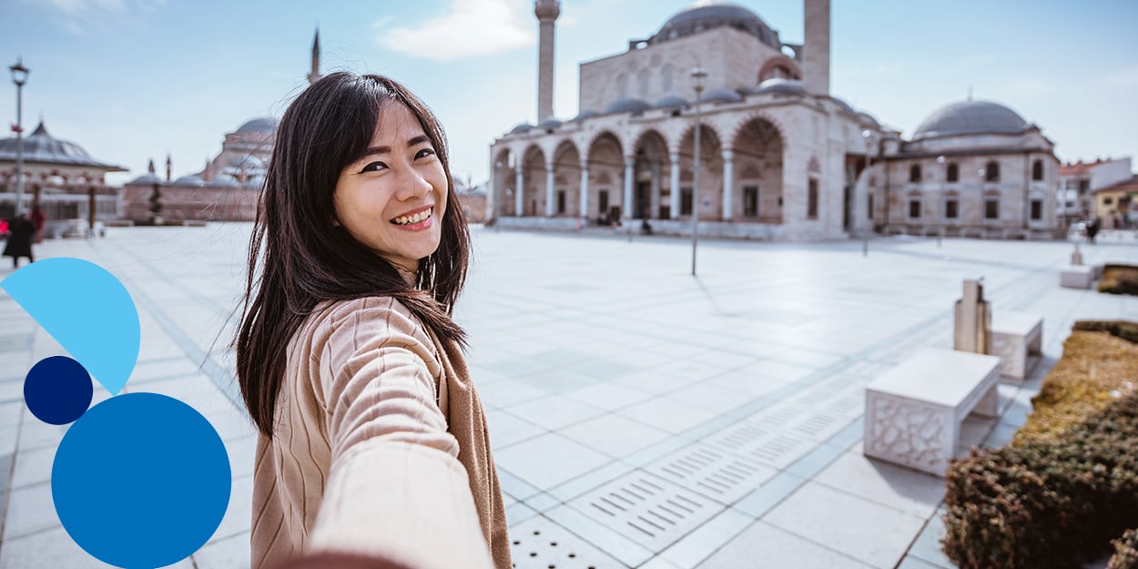 A girl is taking selfie in front of an attraction