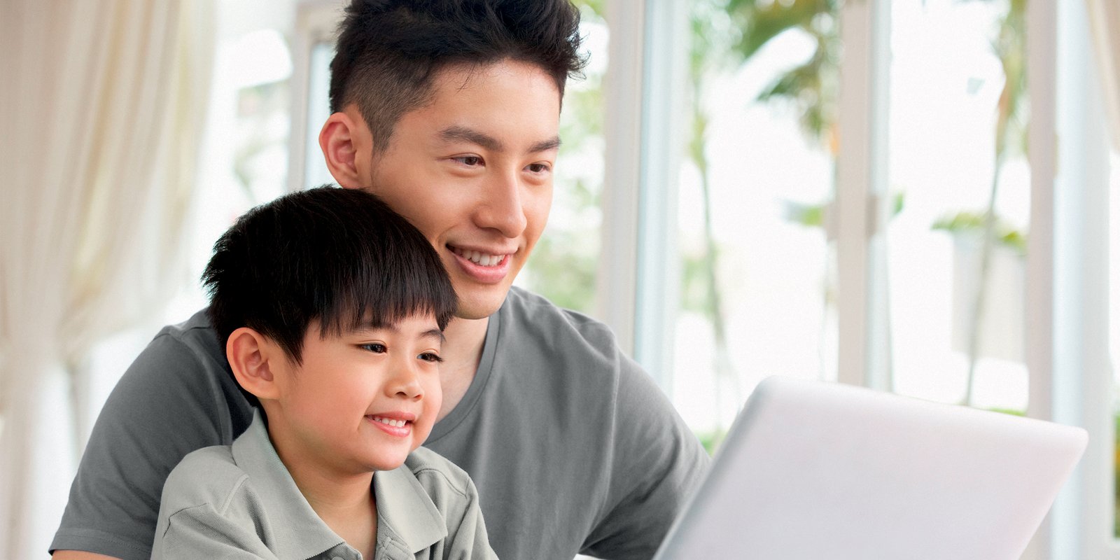 Child and father on laptop