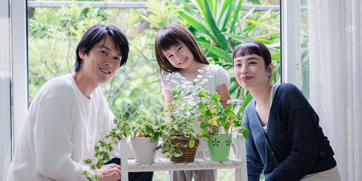 An Asian family with plants