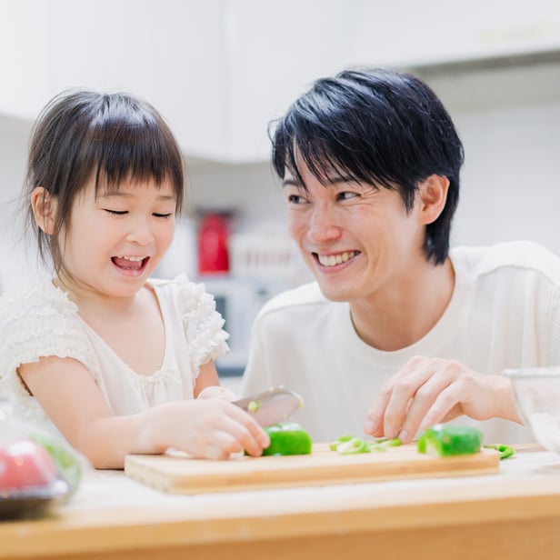 Daddy is cooking with his daughter