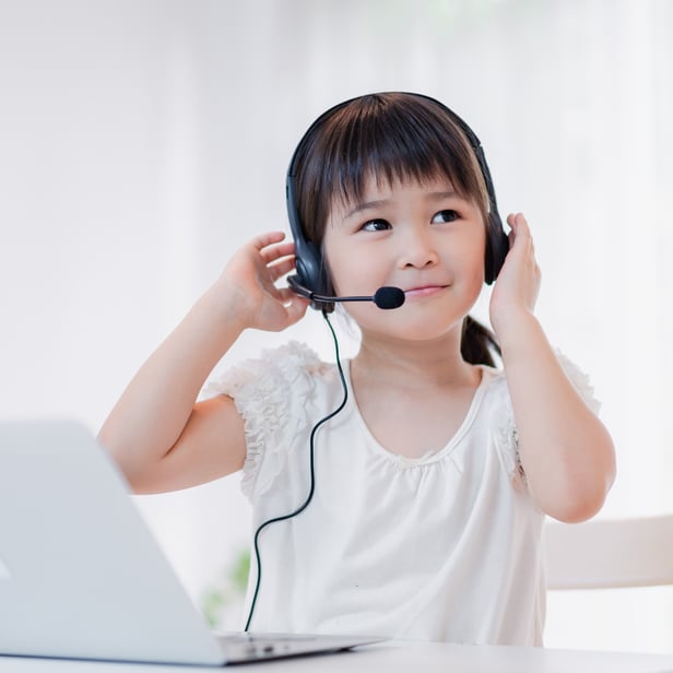 A little girl wearing headset