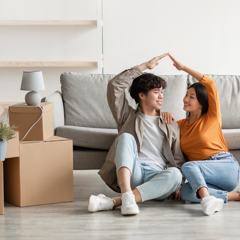 A young couple with arm heart pose