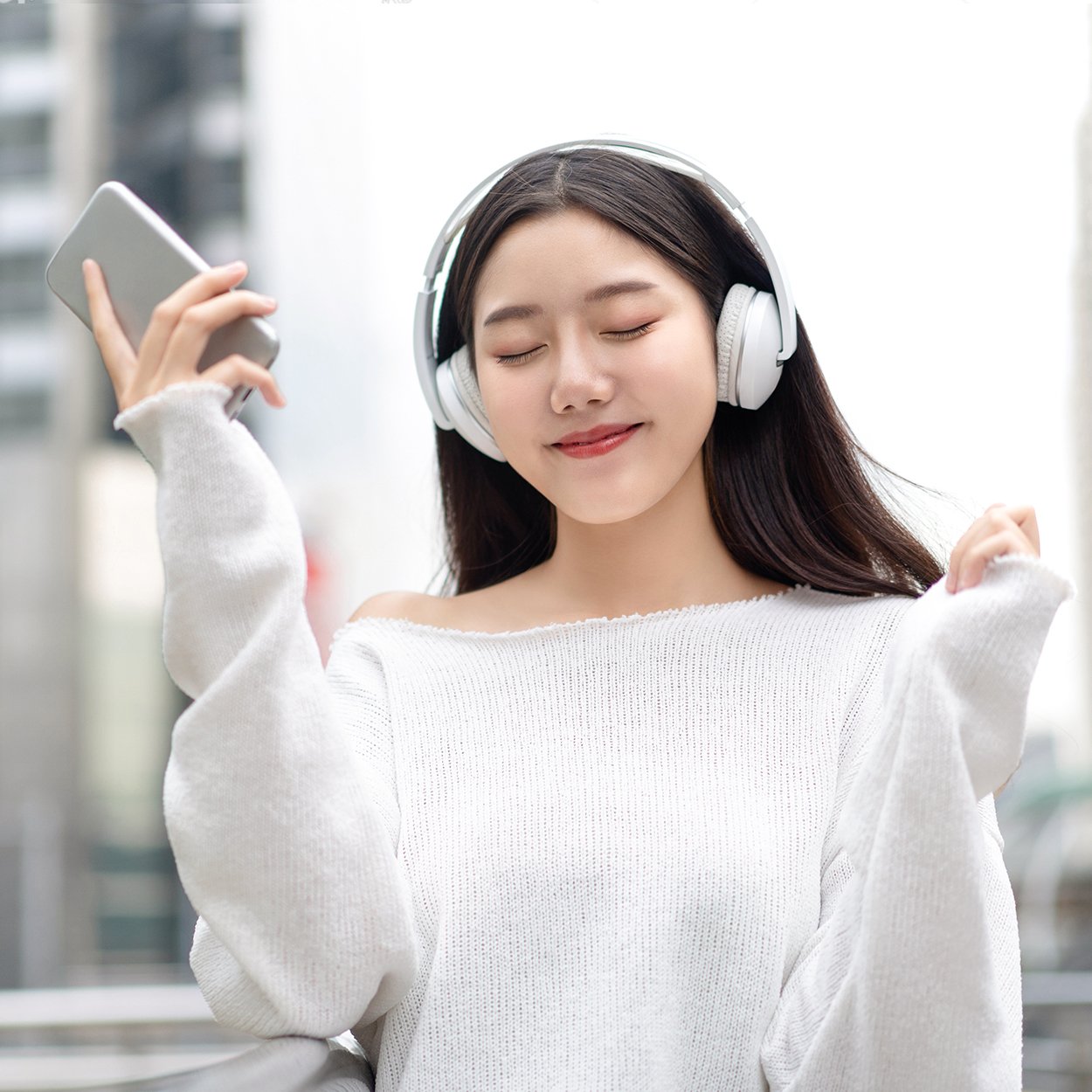 a girl is listening through a headphone