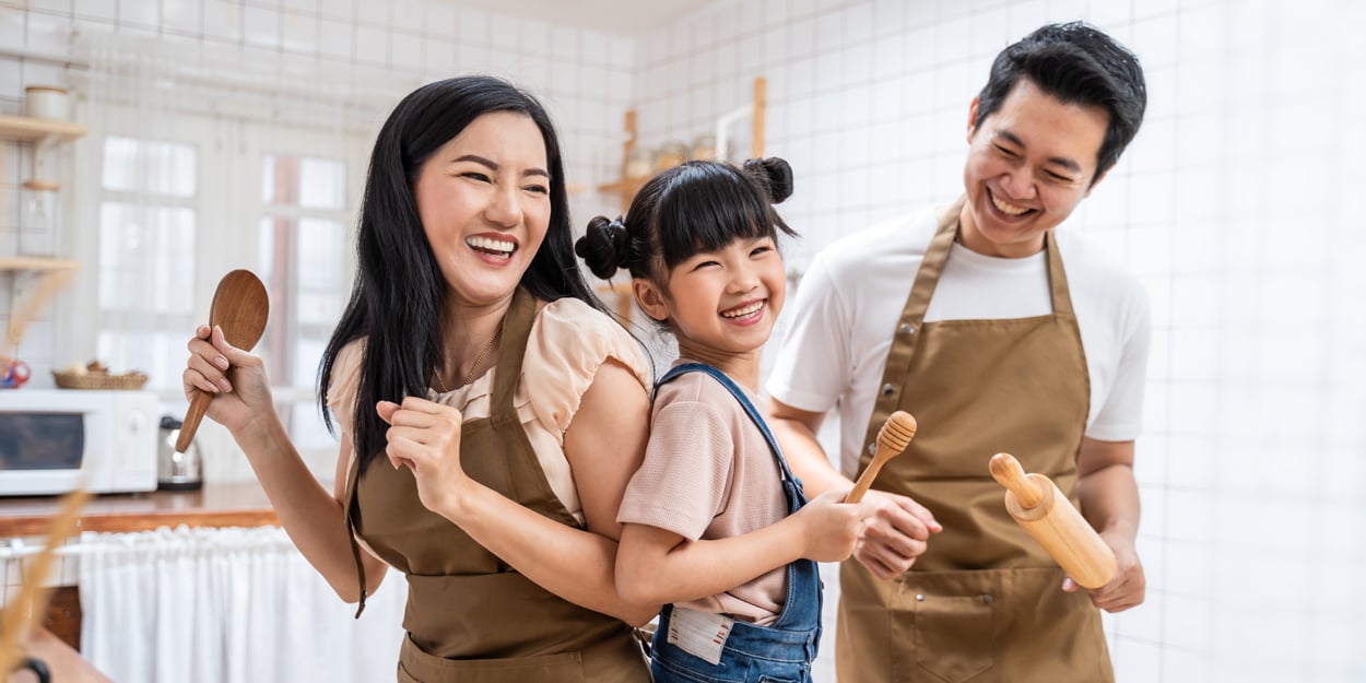 A family is laughing in a kitchen