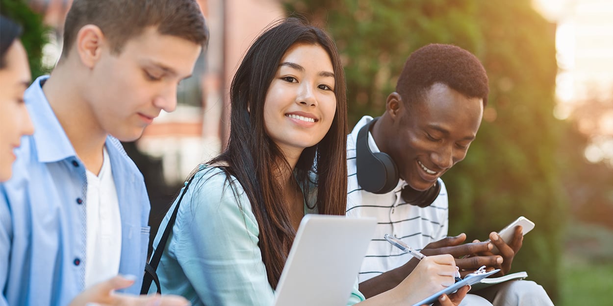 Students of different races discussing project