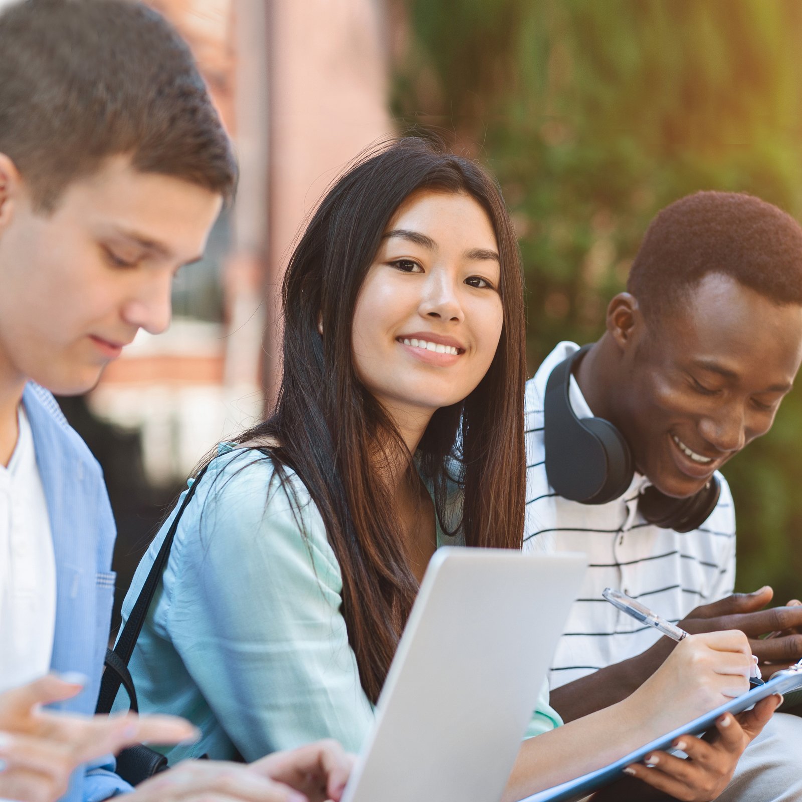 Students of different races discussing project