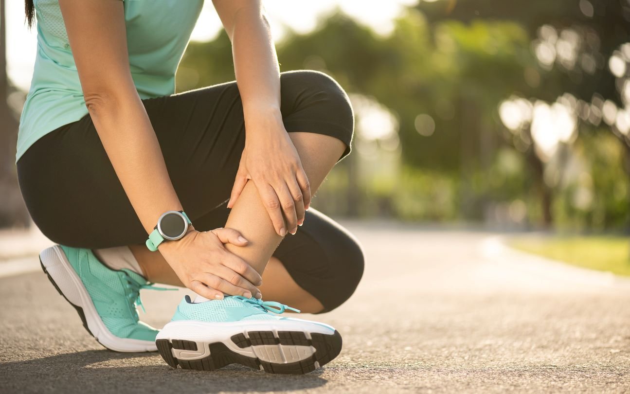sprained ankle woman on pavement