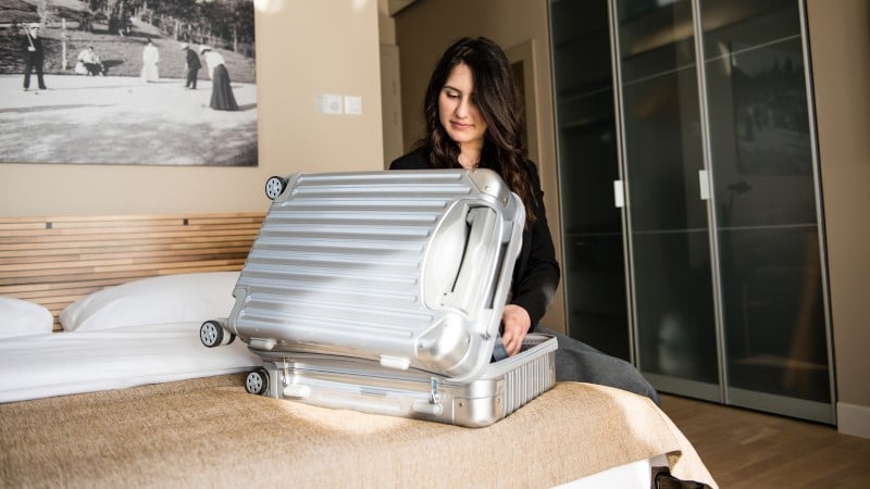 A woman packing her luggage for travel