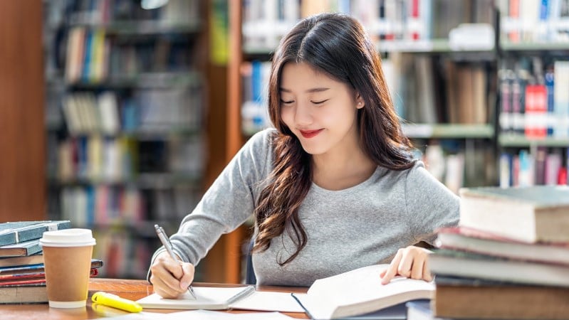 A person writing in a book