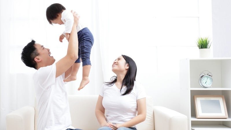 Mother and father with child at home