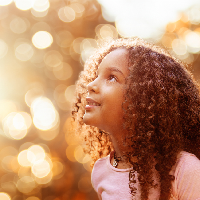 Girl with curls hair looking up