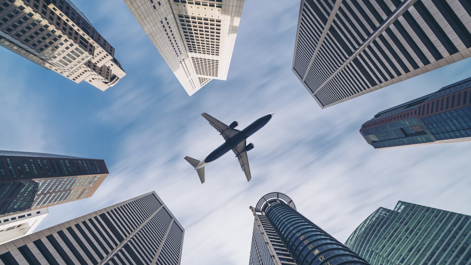 Plane above skyscrapers