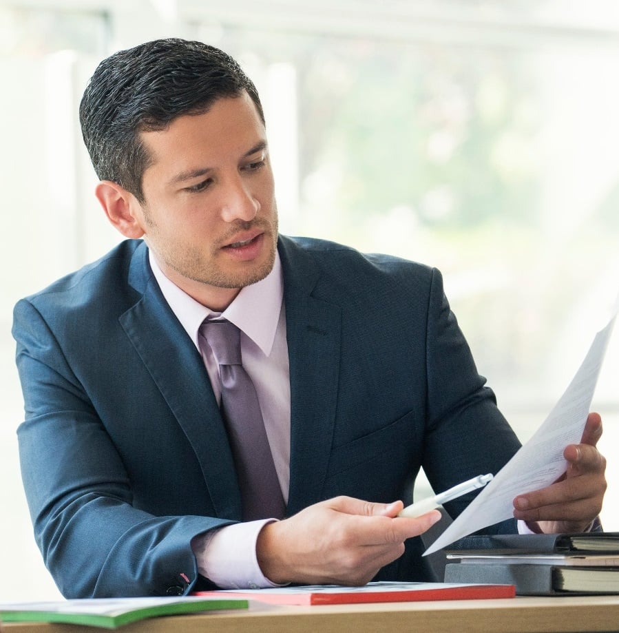 man pointing at paper with pen