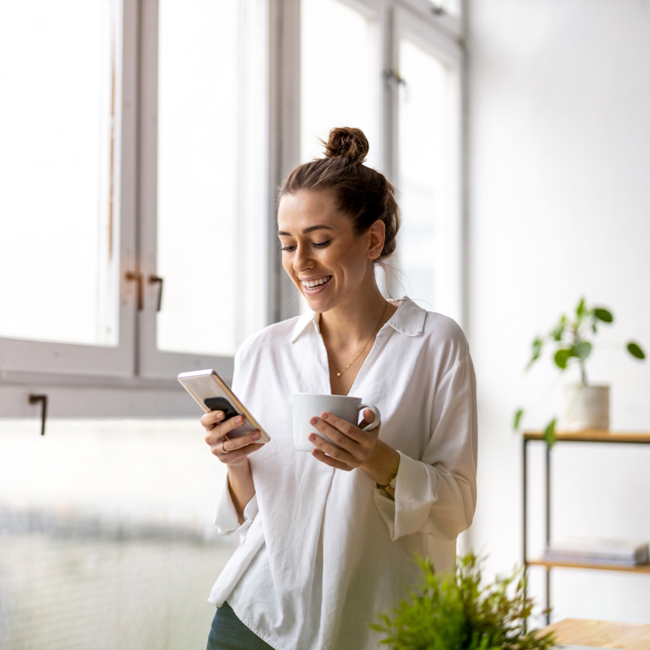 Woman looking at phone smiling