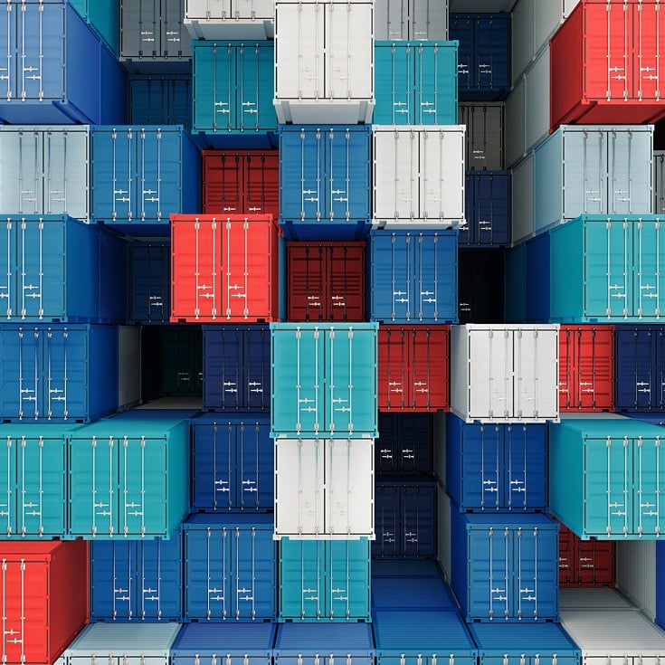 Stacked colorful shipping containers in port.