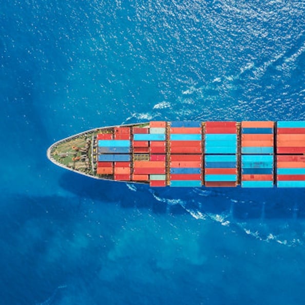 Cargo ship transporting colorful containers at sea.