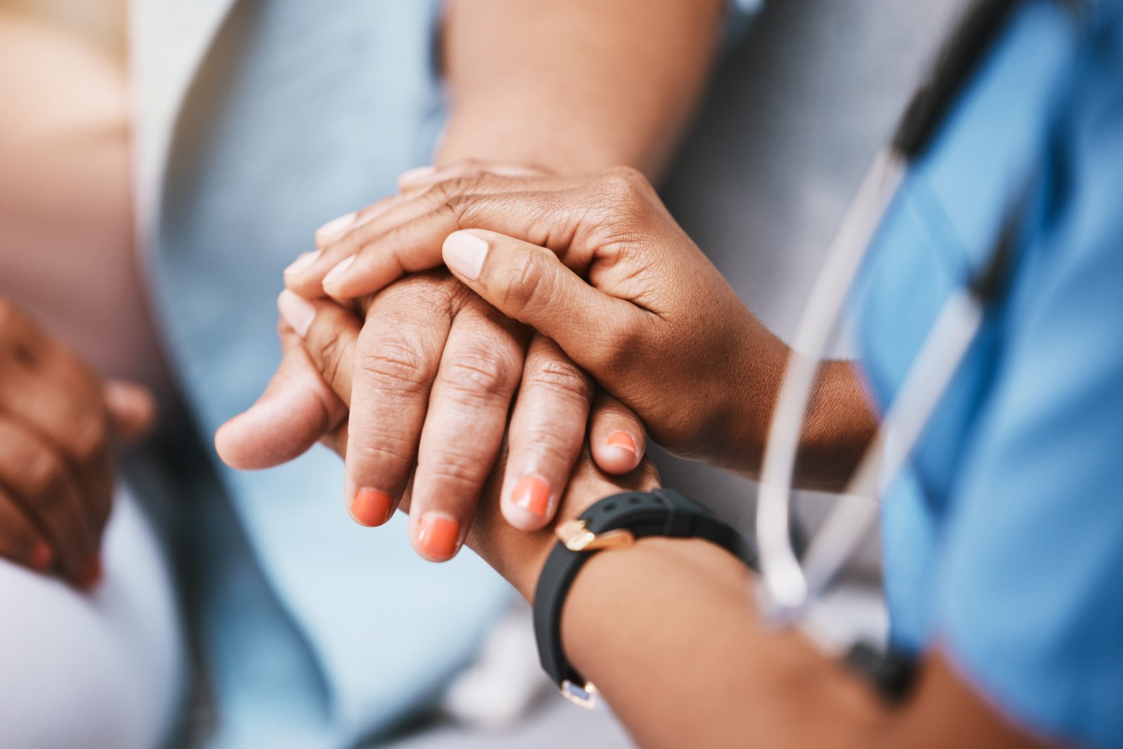 Doctor holding patient hand