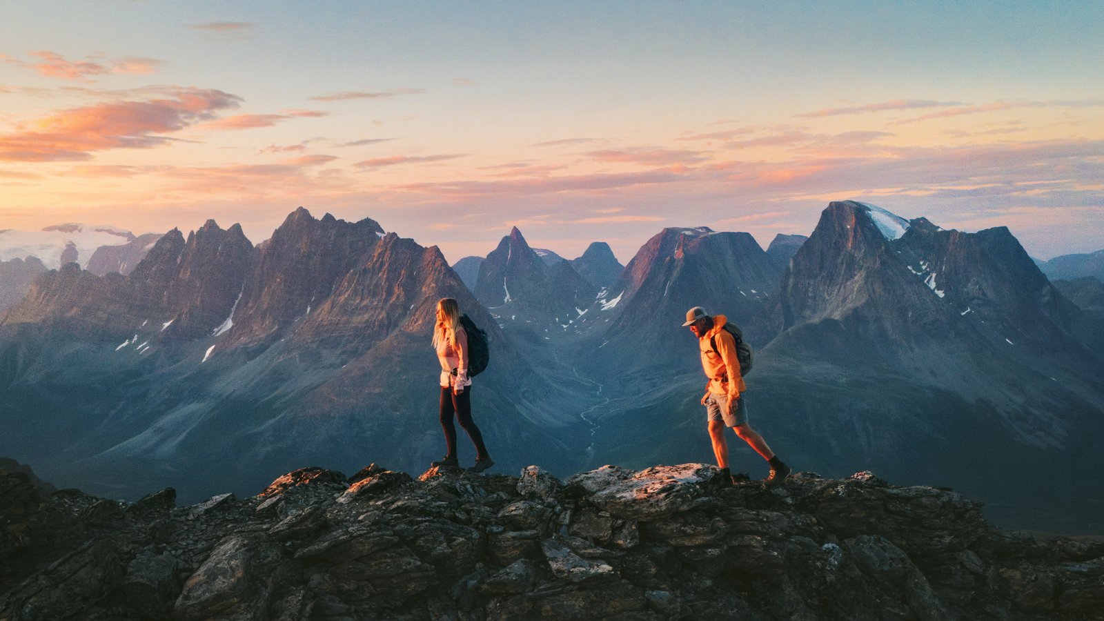 Two people climbing mountains