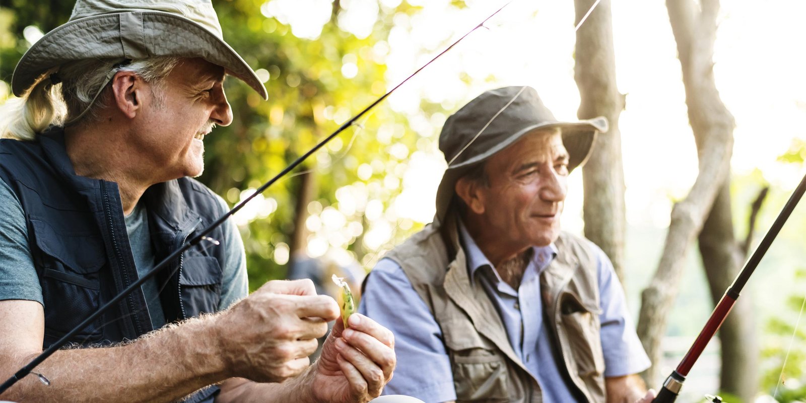 Senior friends fishing by the lake