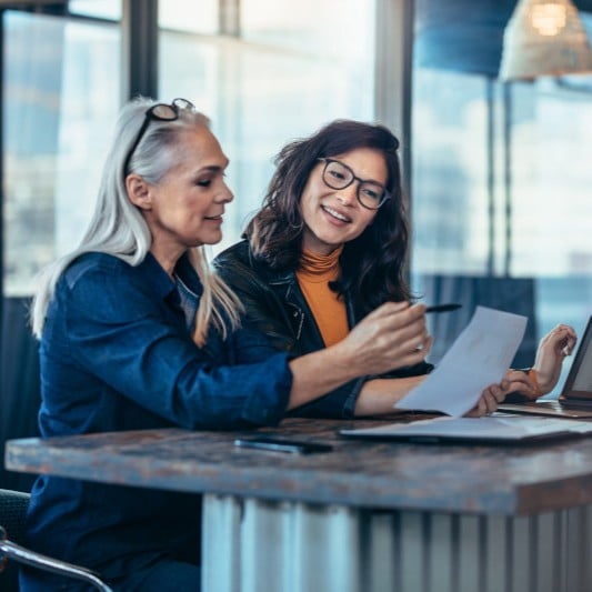 two women talking through a climate assessment