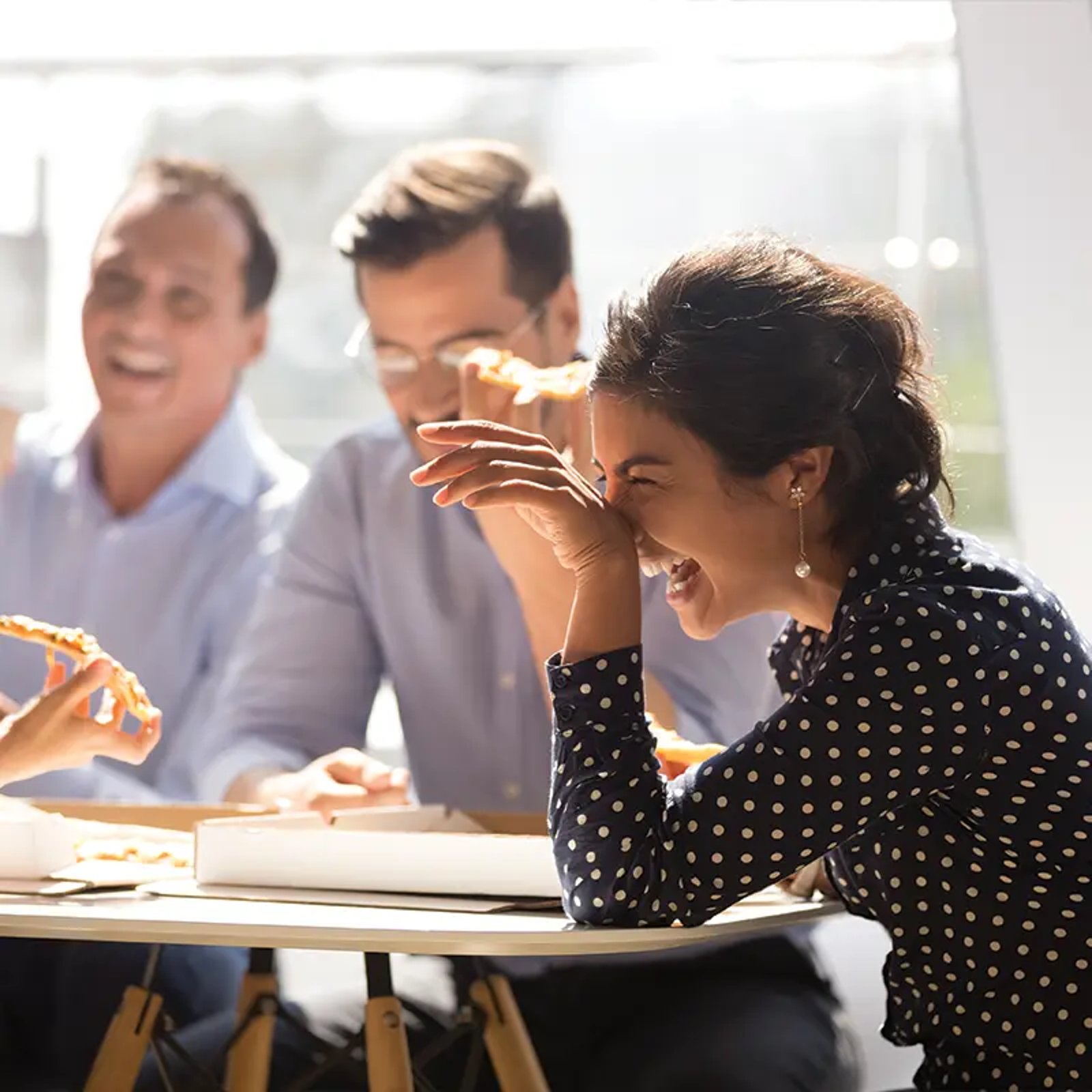 work group in meeting laughing
