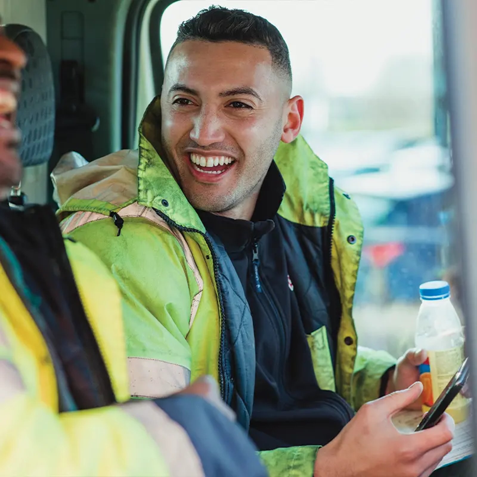 Workers laughing in car