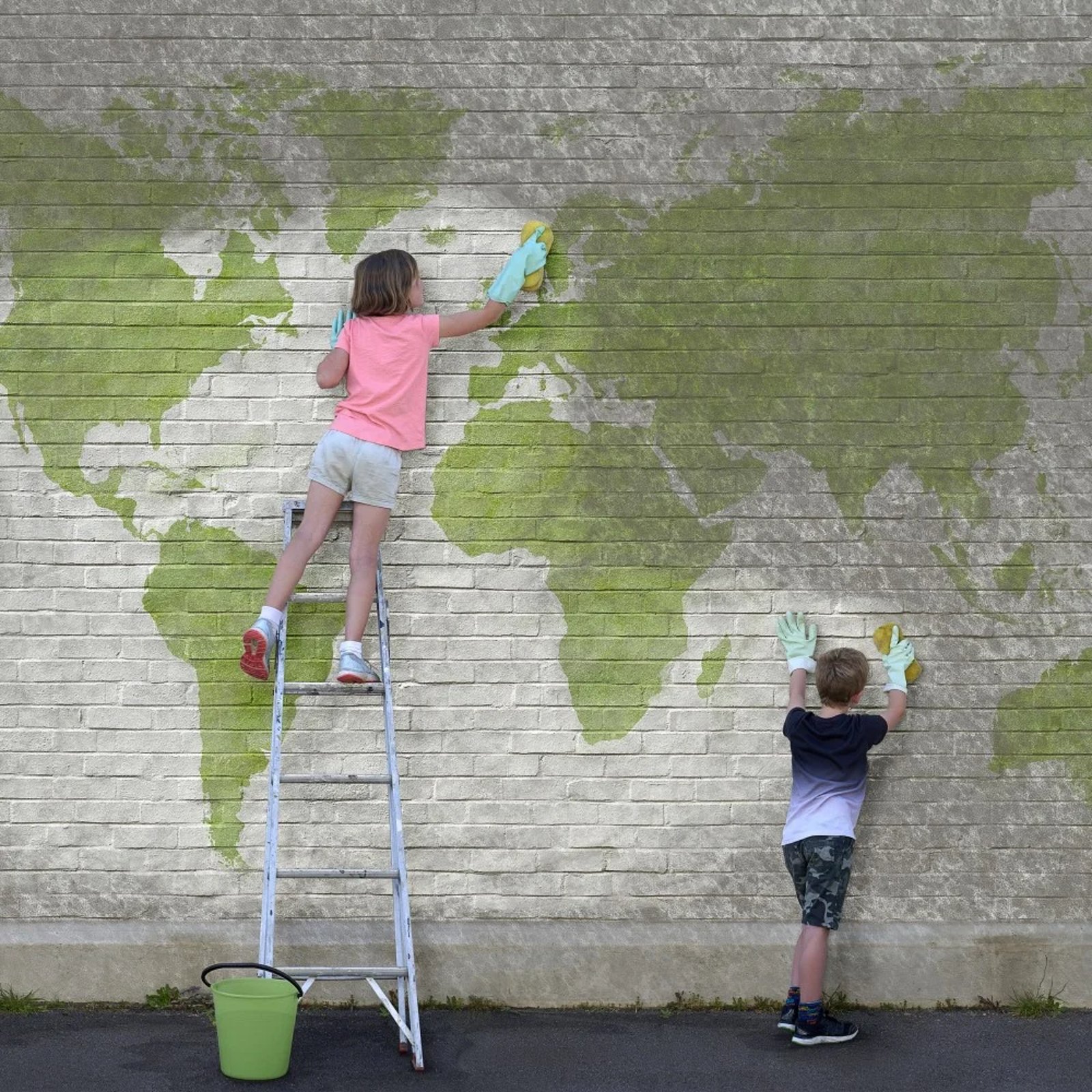 Children wash wall with World map