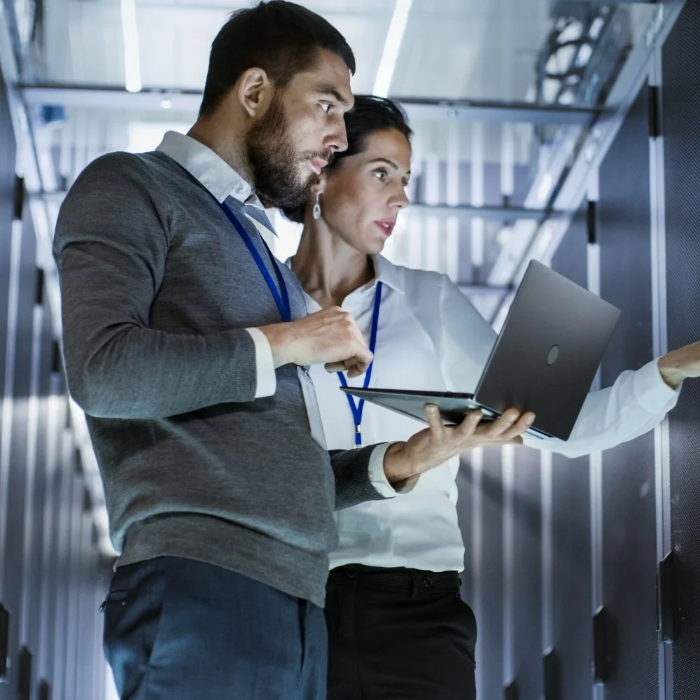 Man and woman running checks at cloud mainframe