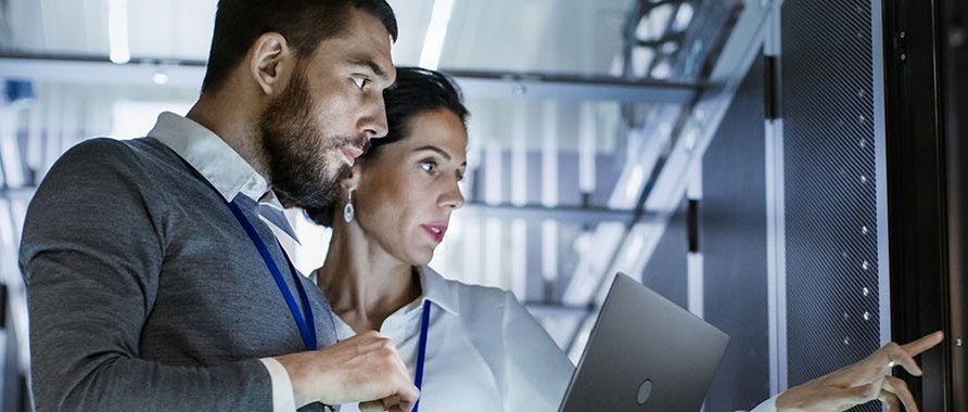 People in server room with tablet