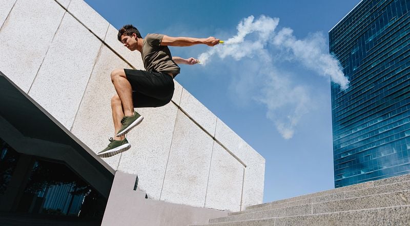 Ein Mann spring geschickt über eine Stiege