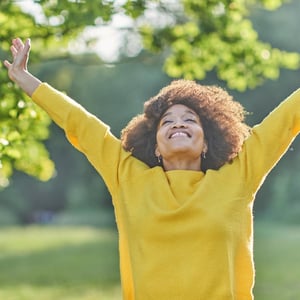 mental wellbeing young woman raising arms