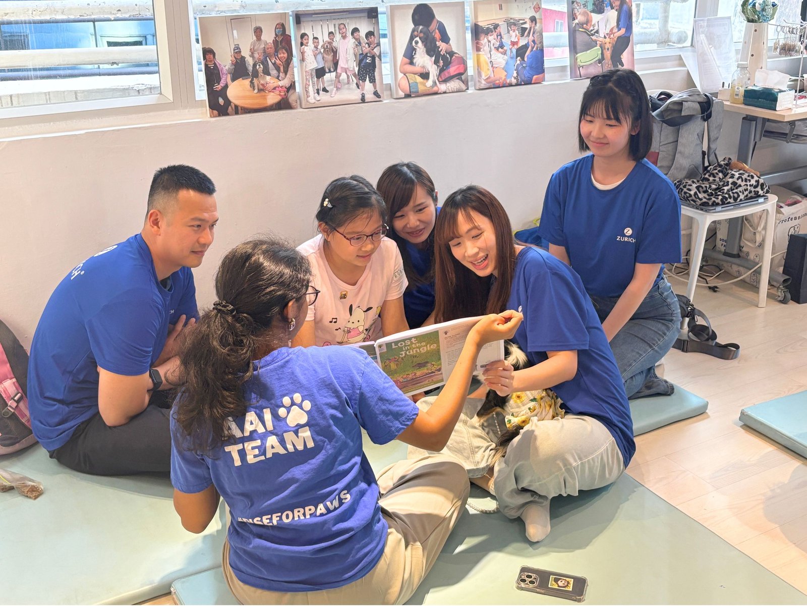 A group of volunteers helping children improve literacy.